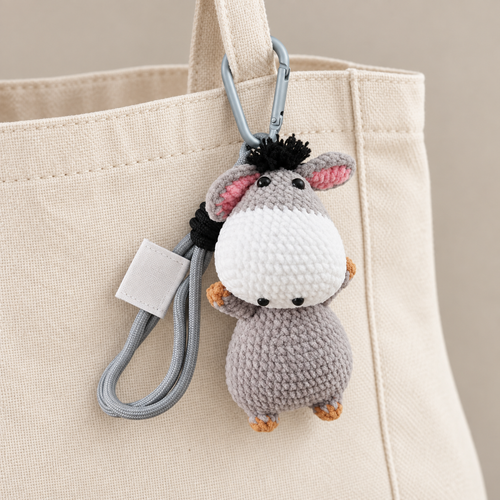 Crochet donkey charm on canvas tote — AI styling; tote not included