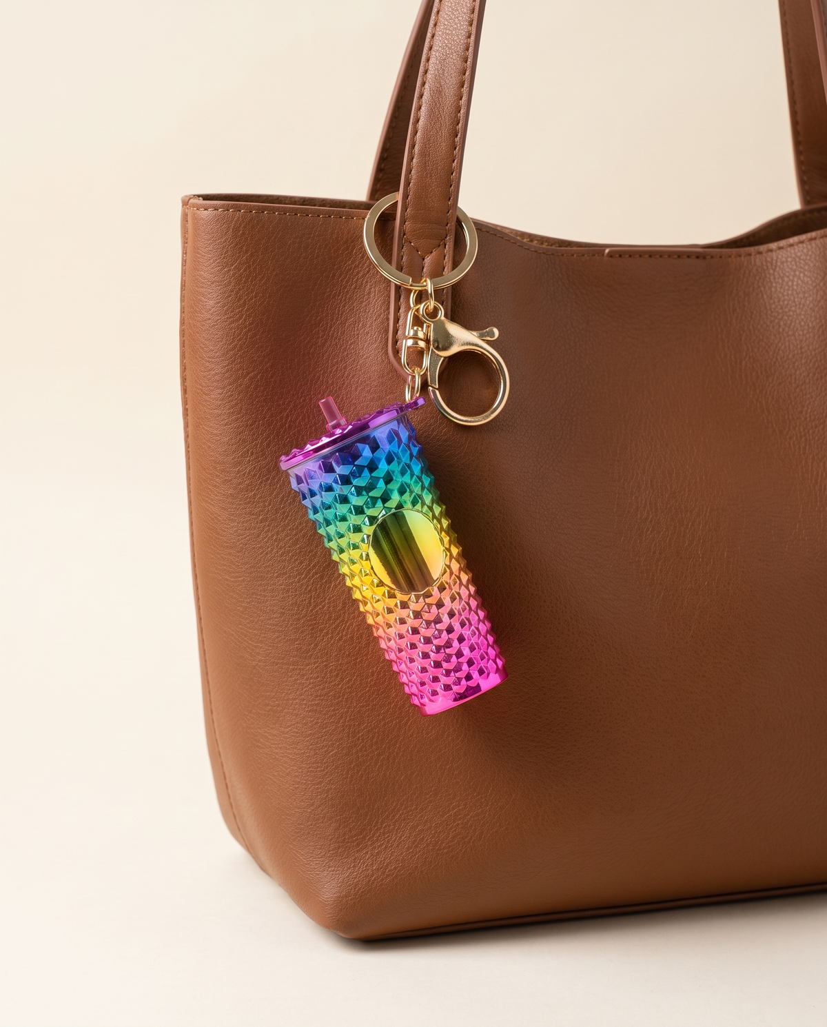 Mini coffee cup acrylic charm on a brown leather tote