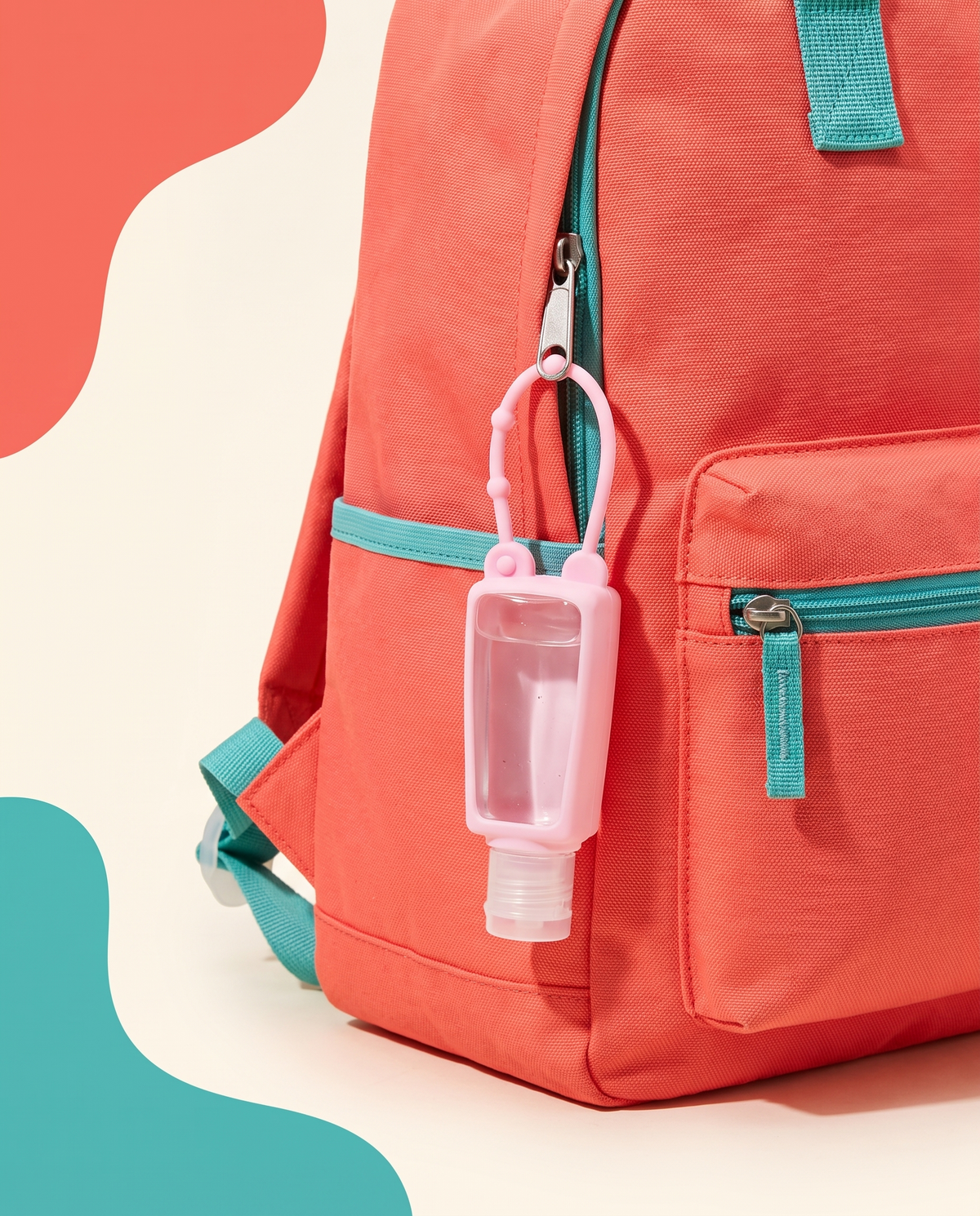 Kids silicone sanitizer holder charm on a colorful backpack