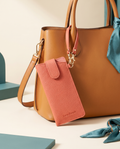 Litchi PU eyeglasses pouch charm clipped to a tan handbag