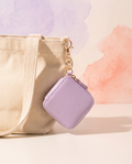 Mini square coin pouch bag charm clipped to a cream tote