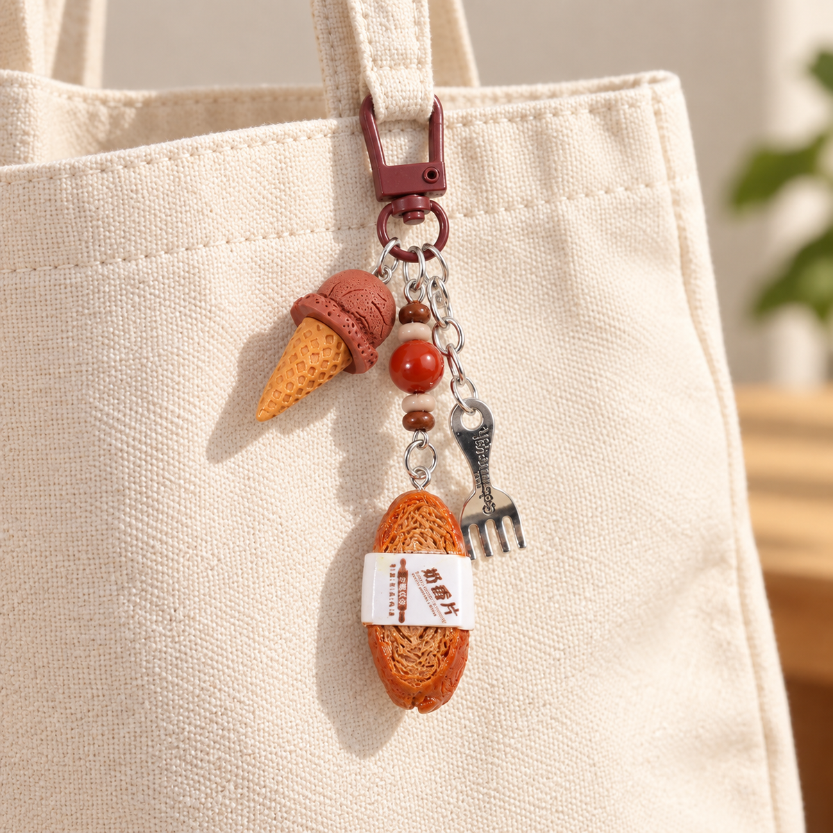 Chocolate ice cream and bread slice charm clipped to a cream canvas bag; bag not included