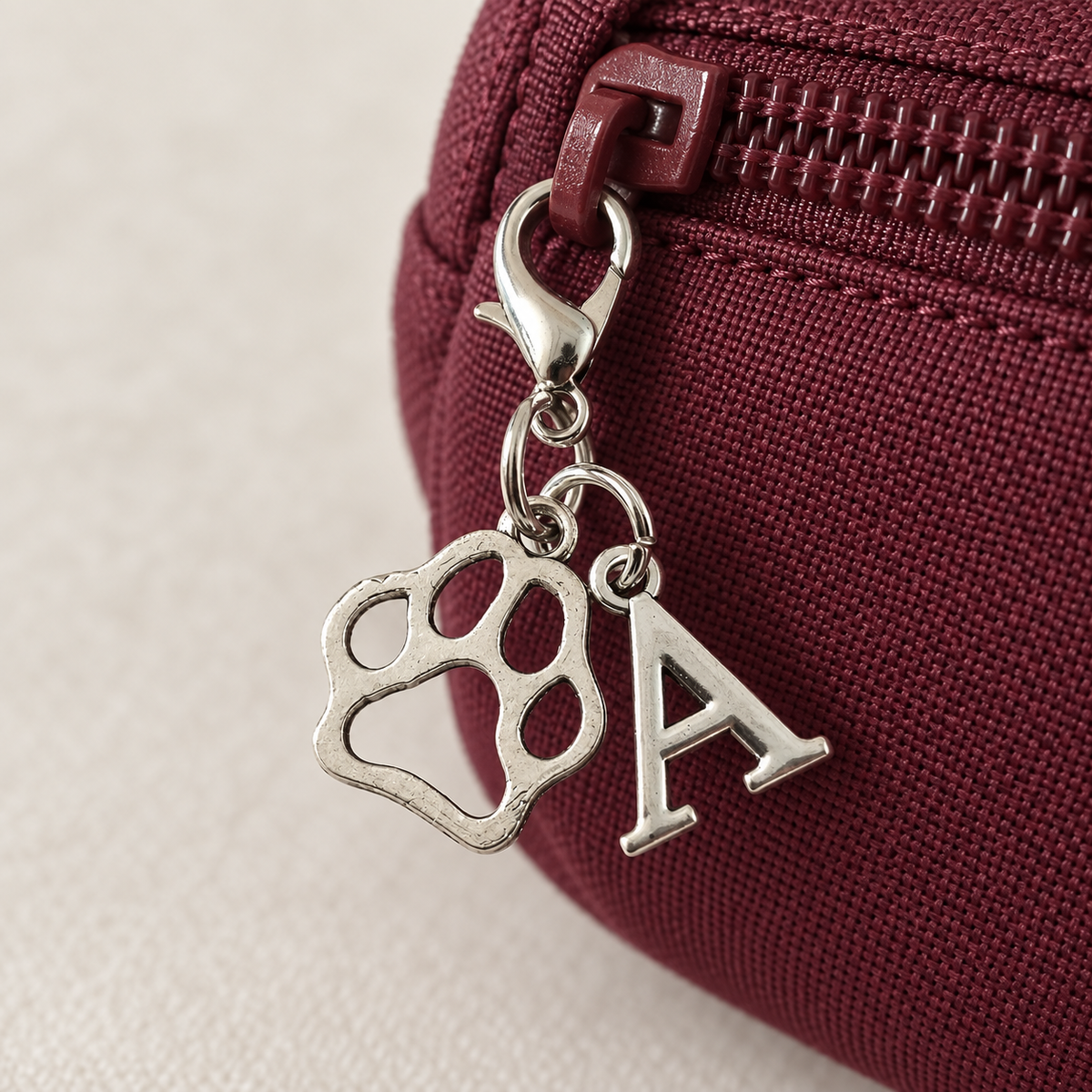 Paw & Initial Bag Charm styled on a bag; bag not included