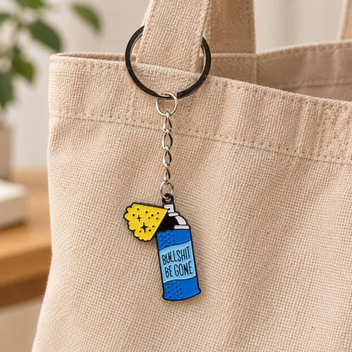 Blue Spray Can illustrated bag charm attached to a handbag