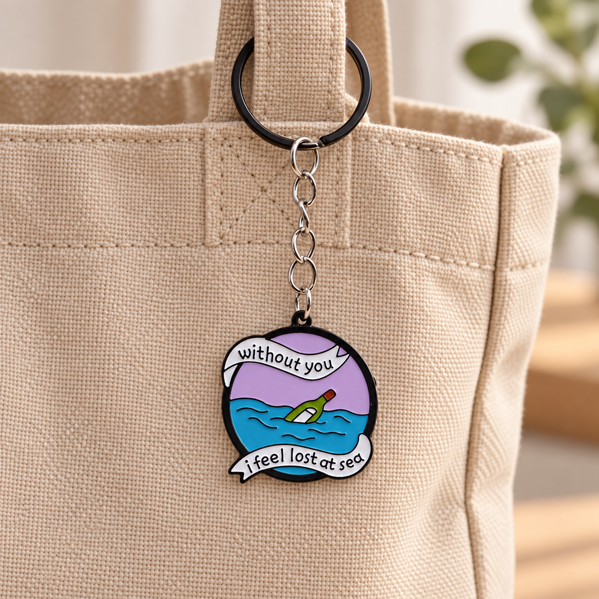 Lost at Sea illustrated bag charm attached to a handbag