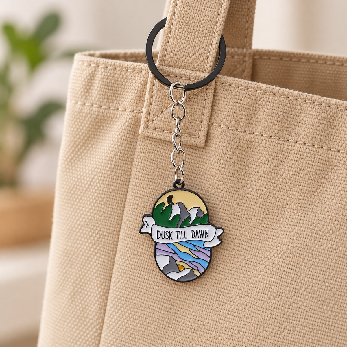 Mountain Badge illustrated bag charm attached to a handbag