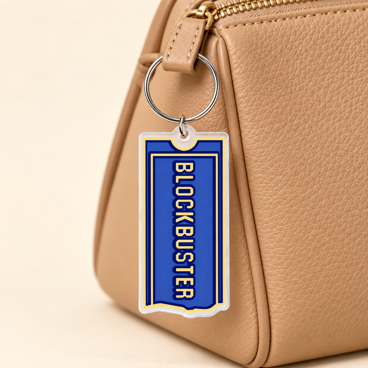 Blue retro video-store ticket acrylic charm styled on a tan bag; bag not included