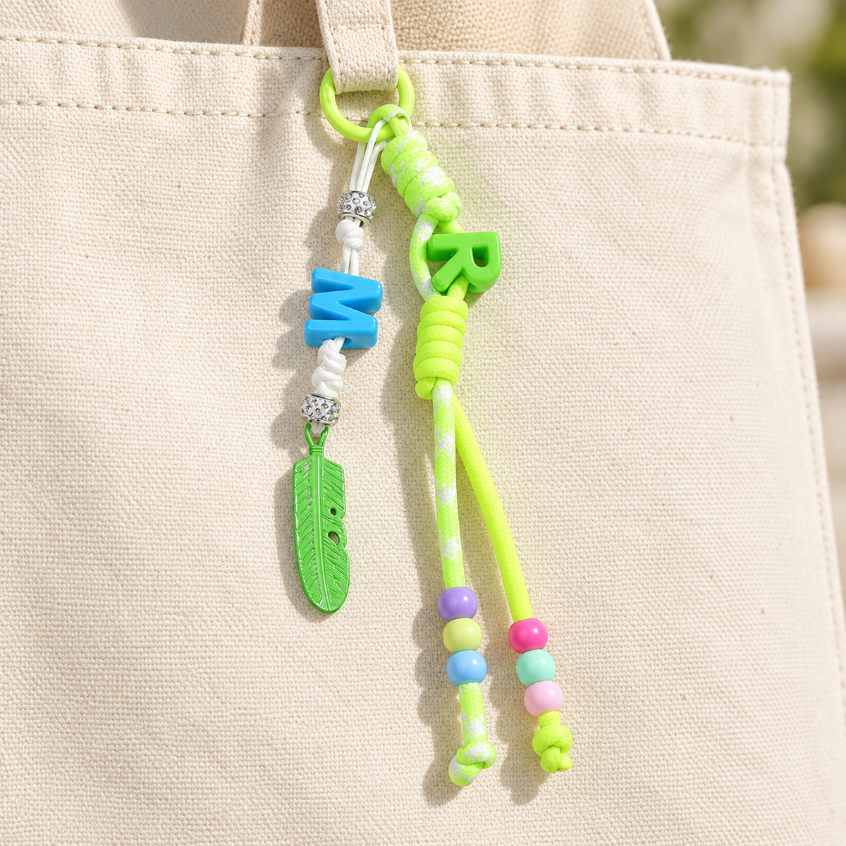 Lime green bag charm attached to a canvas bag; bag not included