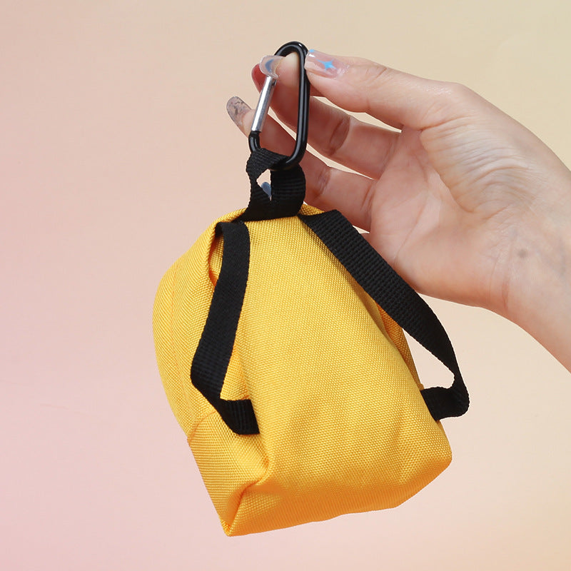 Daisy mini backpack pouch rear view showing straps and attachment clip — Yellow