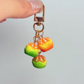 Miniature orange cluster bag charm — supplier photograph