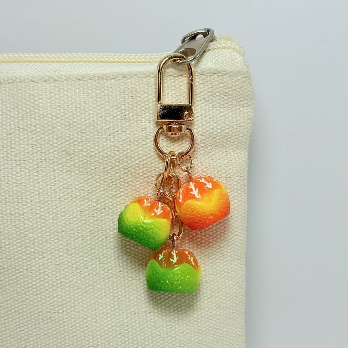 Miniature orange cluster bag charm — supplier photograph