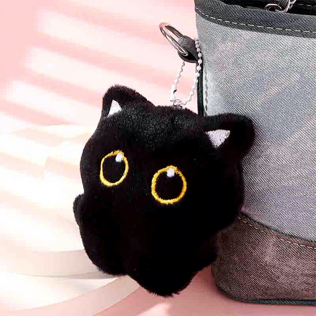 Black cat plush charm attached to a bag