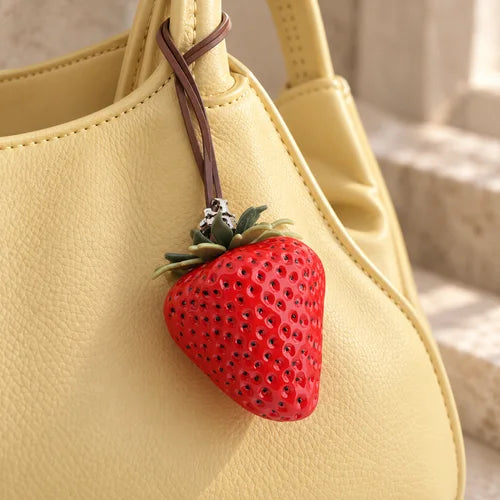 Strawberry Bag Charm styled on a handbag