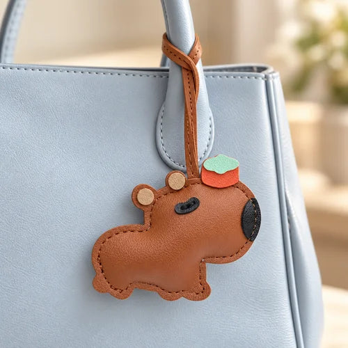 Capybara Bag Charm — Brown styled on a handbag