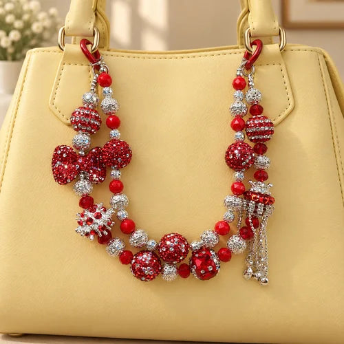 Red Sparkle Beaded Bag Charm Pair styled on a handbag