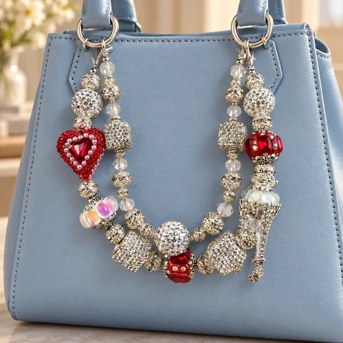 Ruby Heart Beaded Bag Charm Pair styled on a handbag