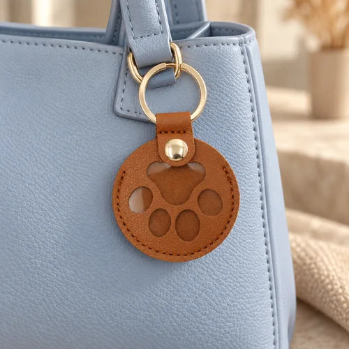 Paw Keepsake Charm Pair — Brown styled on a handbag