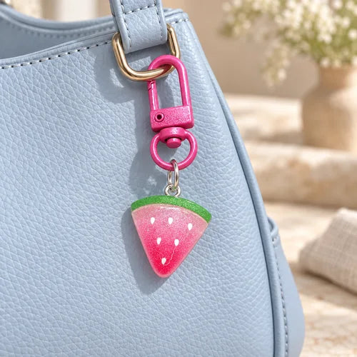 Glitter Watermelon Charm Pair styled on a handbag