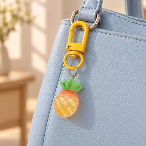 Glitter Pineapple Charm Pair styled on a handbag